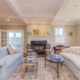 Luxury traditional living room remodel in Marblehead featuring coffered ceilings, marble fireplace, and elegant French doors.